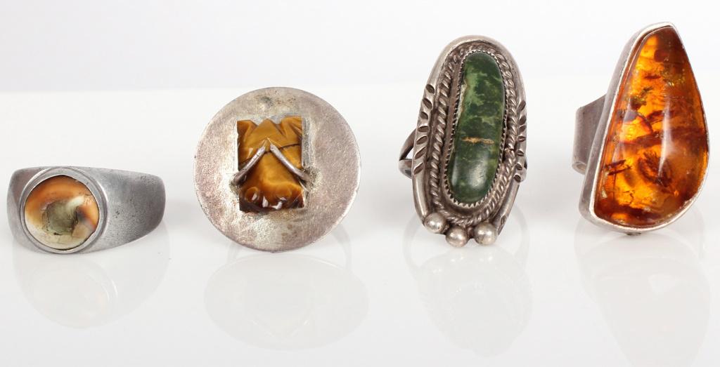 STERLING SILVER SCANDINAVIAN RINGS - LOT OF 4: STERLING SILVER SCANDINAVIAN RINGS - LOT OF 4 Sterling silver solitaire rings. Lot of 4 to include one with amber in Scandinavian style, one with hand carved tiger's eye depicting a frog, and two with