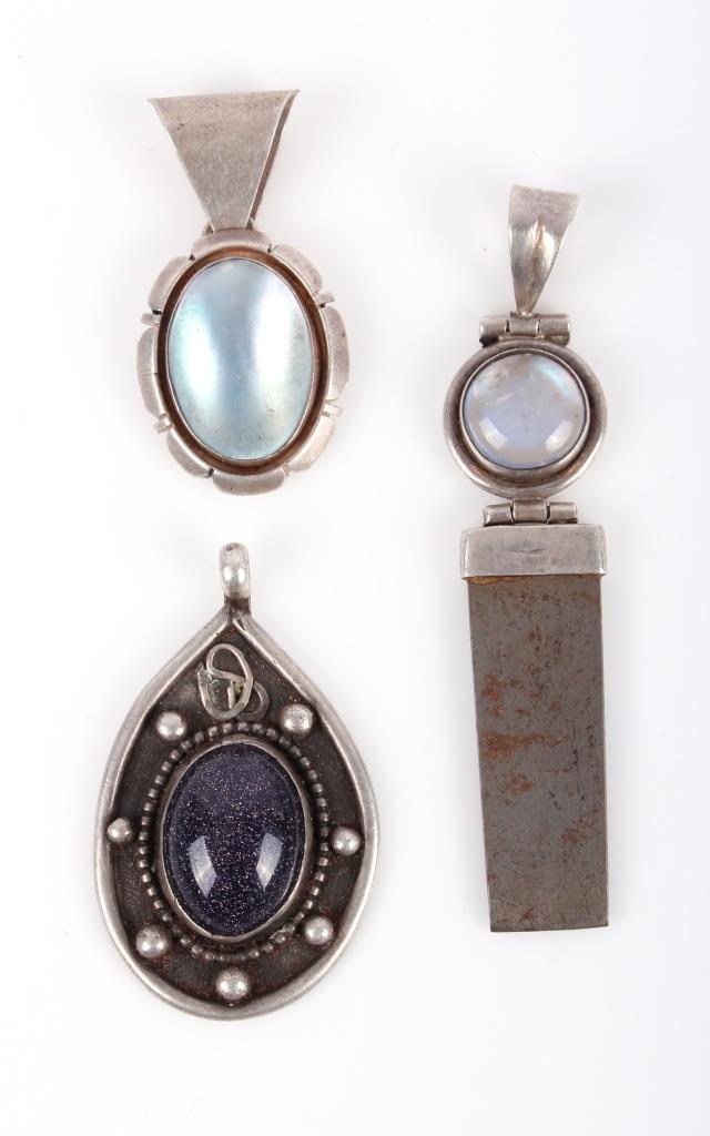 .925 MOONSTONE AND BLUE GOLDSTONE PENDANTS LOT-3: .925 MOONSTONE AND BLUE GOLDSTONE PENDANTS LOT-3 .925 Silver moonstone pendants and one blue goldstone pendant with teardrop shape design Weight: 27.1