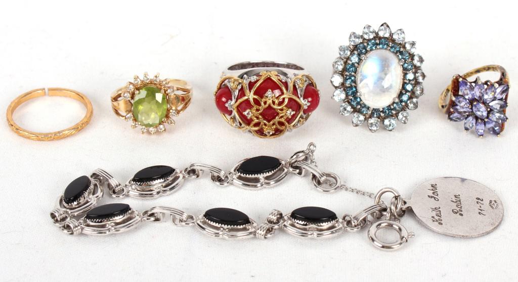.925 STERLING RINGS W/ SILVER PENDANT - LOT OF 6: .925 STERLING RINGS W/ SILVER PENDANT - LOT OF 6 Sterling silver rings (5) with varying color gem stones to include moonstone, red coral, etc. Costume bracelet with sterling silver charm inscribed "Ke