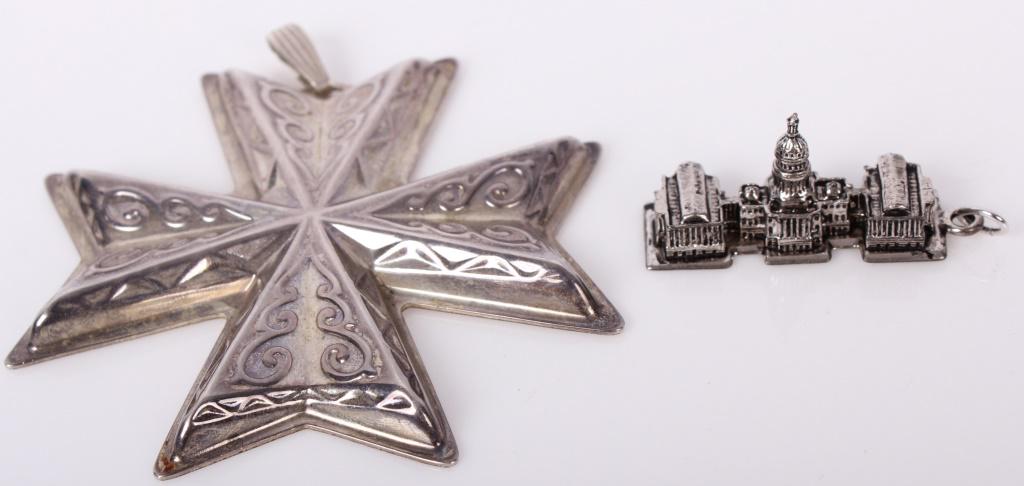STERLING SILVER HANGING ORNAMENTS - LOT OF 2: STERLING SILVER HANGING ORNAMENTS - LOT OF 2 Sterling silver hanging ornaments. Lot of 2 to include one Reed and Barton 1977 Christmas Cross and one Smithsonian Institution detailed representation of 