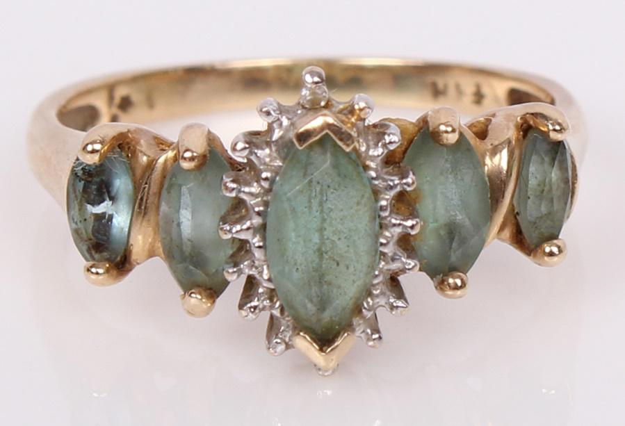 10K YELLOW GOLD EMERALD GREEN BERYL LADIES RING: 10K YELLOW GOLD EMERALD GREEN BERYL LADIES RING 10k yellow gold blue green beryl ladies ring with a center .35ct stone, 2, .15ct stones, and 2, .8ct stones equaling .76ctw. Weight: 3.2 GramsSize: 7.0 