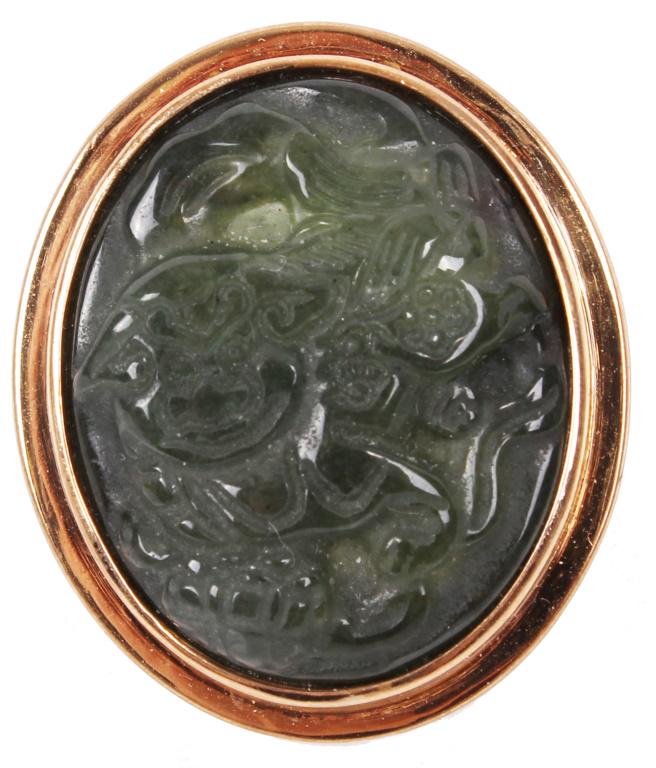 AMY KAHN RUSSELL BRONZE CARVED JADE RING: AMY KAHN RUSSELL BRONZE CARVED JADE RING Amy Kahn Russell bronze carved jade ring depicting a foo lion. Size: 5.0 Condition: Very fine
