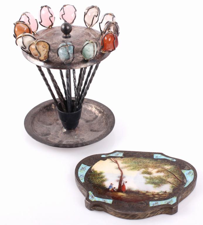 TWISTED SILVER FOOD PICK SET & ENAMELED COMPACT: TWISTED SILVER FOOD PICK SET & ENAMELED COMPACT Lot of two silver plate items to include: 12 piece food pick set with semi-precious stones, and enameled makeup case. Size: 6" tallCondition: Wear comme