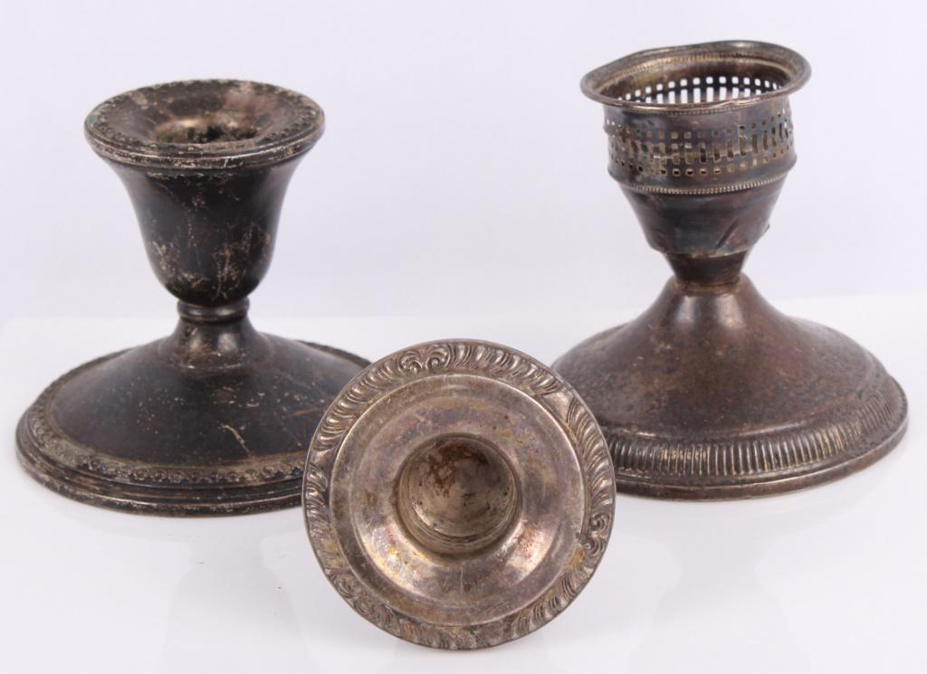 STERLING SILVER WEIGHTED CANDLE HOLDERS - LOT OF 3: STERLING SILVER WEIGHTED CANDLE HOLDERS - LOT OF 3 Sterling silver weighted candle holders. Lot of 3 to include one made by Rogers, one made by Ouchi Creation, and one of unknown origin. Weight: 529.4