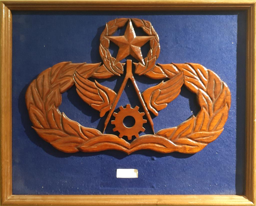 MASONIC FRAMED WOOD CARVING: MASONIC FRAMED WOOD CARVING Masonic wood carving on wood framed, blue felt backdrop. Depicts a gear, a compass, a pair of wings, a wreathe, and a star. Size: 18.25 X 22.5"Condition: Very Fine.