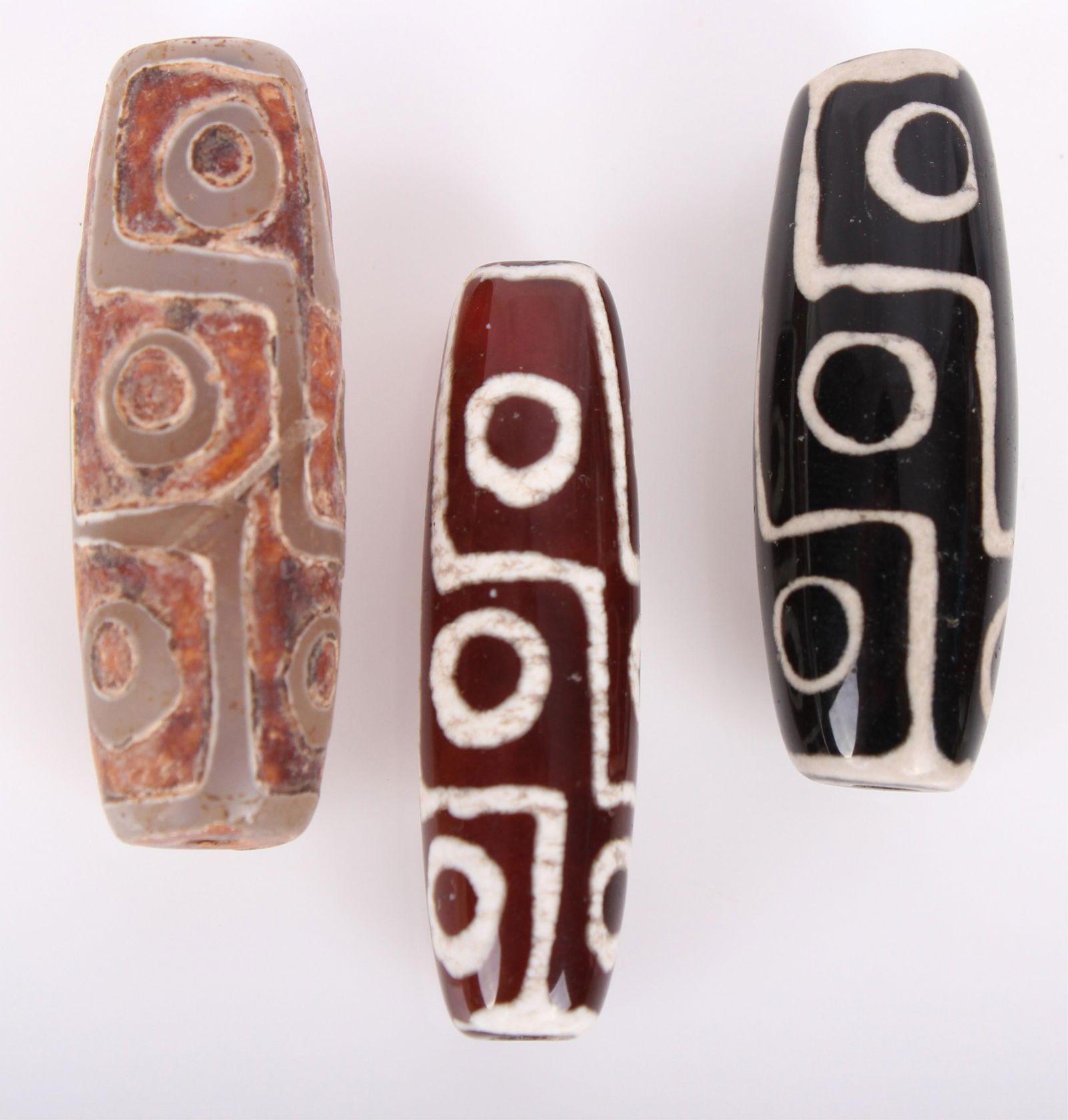 TIBETAN ANTIQUE AGATE BEADS - PROTECTIVE AMULETS: TIBETAN ANTIQUE AGATE BEADS - PROTECTIVE AMULETS Tibetan antique agate beads - possible Dzi bead - lot of 3. Each agate bead has 9 "eyes" originally thought to counteract the "Evil Eye" of Persia. Siz