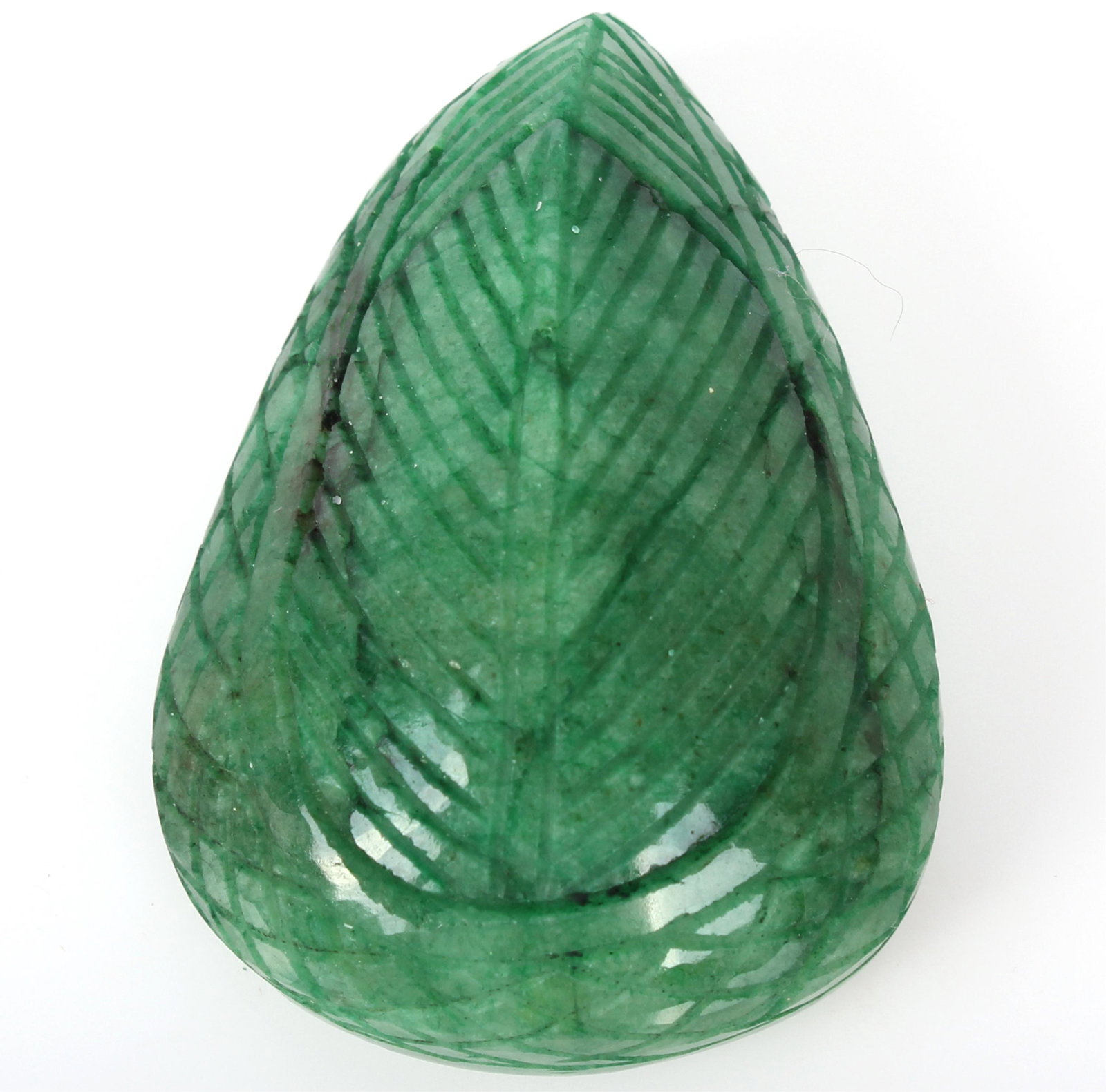 ZAMBIAN HAND CARVED TEAR DROP SHAPED EMERALD 411CT: ZAMBIAN HAND CARVED TEAR DROP SHAPED EMERALD 411CT Zambian hand carved emerald mineral specimen with leaf design on the front and back. Tear drop shaped. Weight: 82.7 Grams