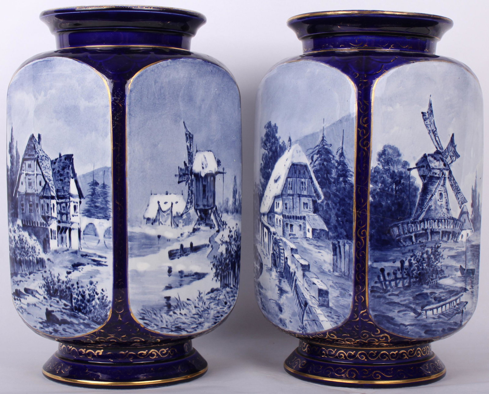BLUE AND WHITE TIN GLAZED DELFT VASES - LOT OF 2: BLUE AND WHITE TIN GLAZED DELFT VASES - LOT OF 2 Delftware tin glazed blue and white earthenware vases made in the Netherlands. Each piece is different but both depict farm scenes and windmills of Hol
