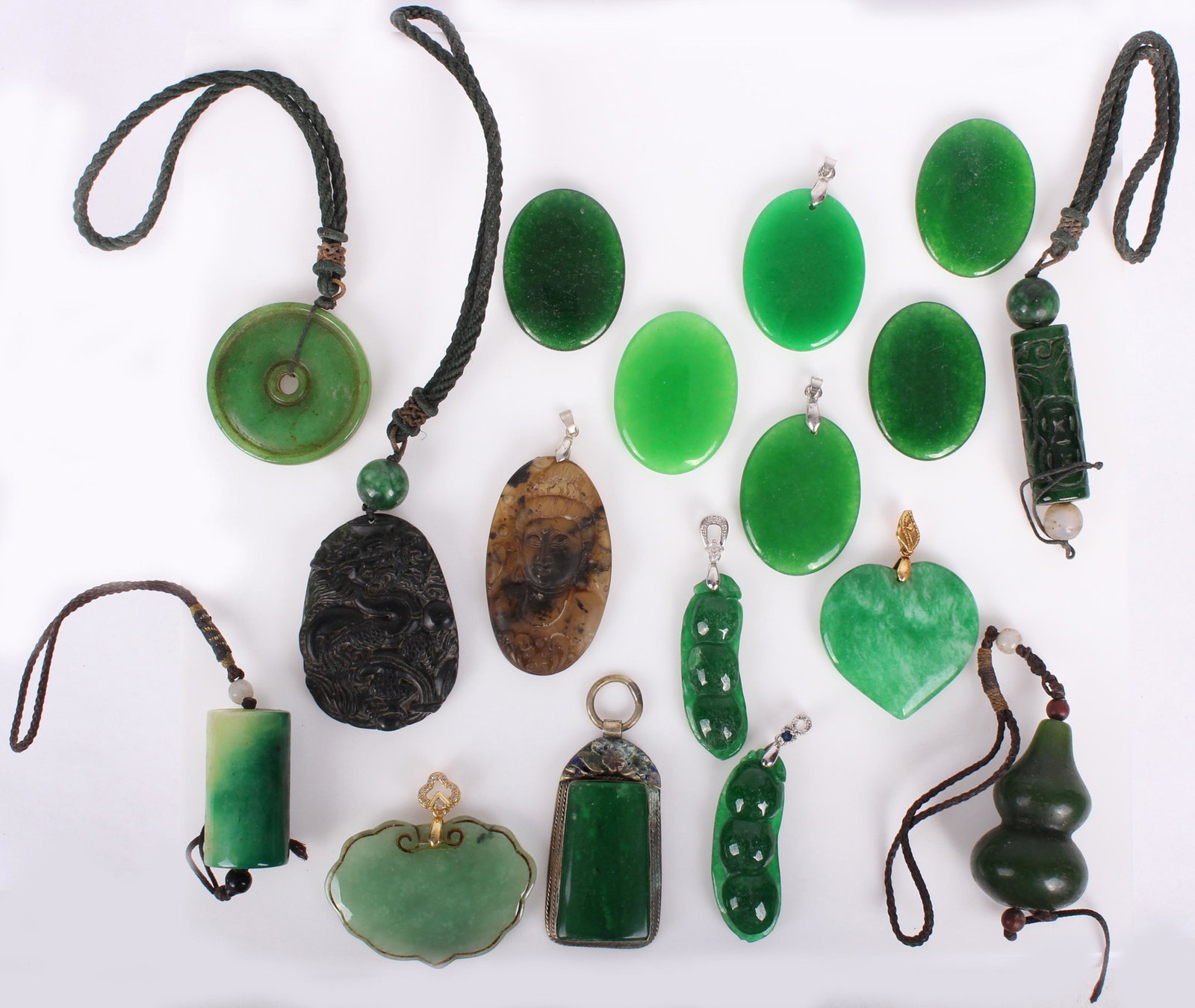 CHINESE CARVED GREEN STONE PENDANTS - LOT OF 17: CHINESE CARVED GREEN STONE PENDANTS - LOT OF 17 Chinese carved green stone pendants - lot of 17. Some test as Jadeite. Size: 2" Largest