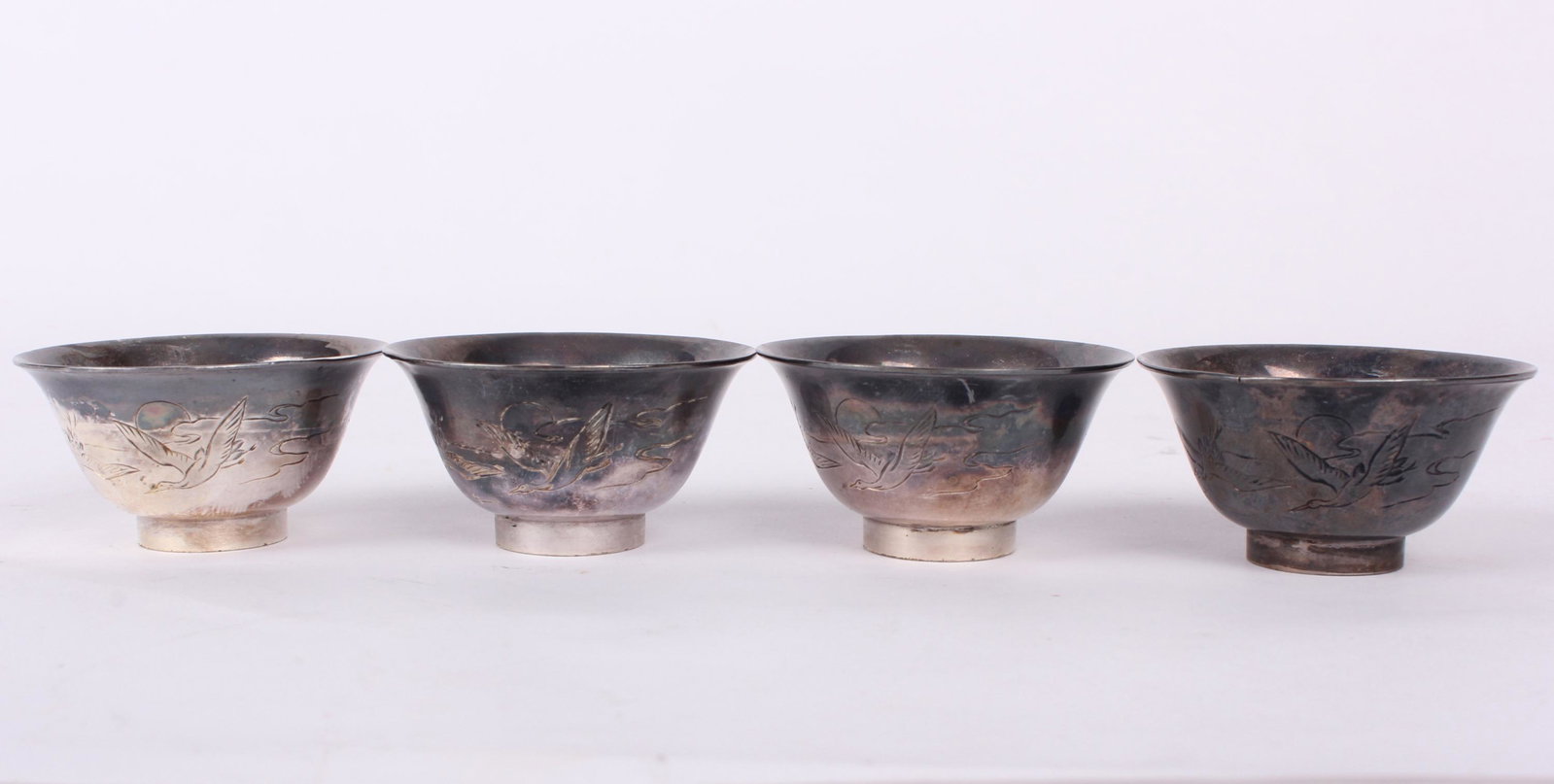 STERLING SILVER SAKE SHOT GLASSES - LOT OF 4: 97149STERLING SILVER SAKE SHOT GLASSES - LOT OF 4 Sterling silver Japanese Sake shot glasses - lot of 4. Weight: 73.1 Grams Size: 1.25" Tall