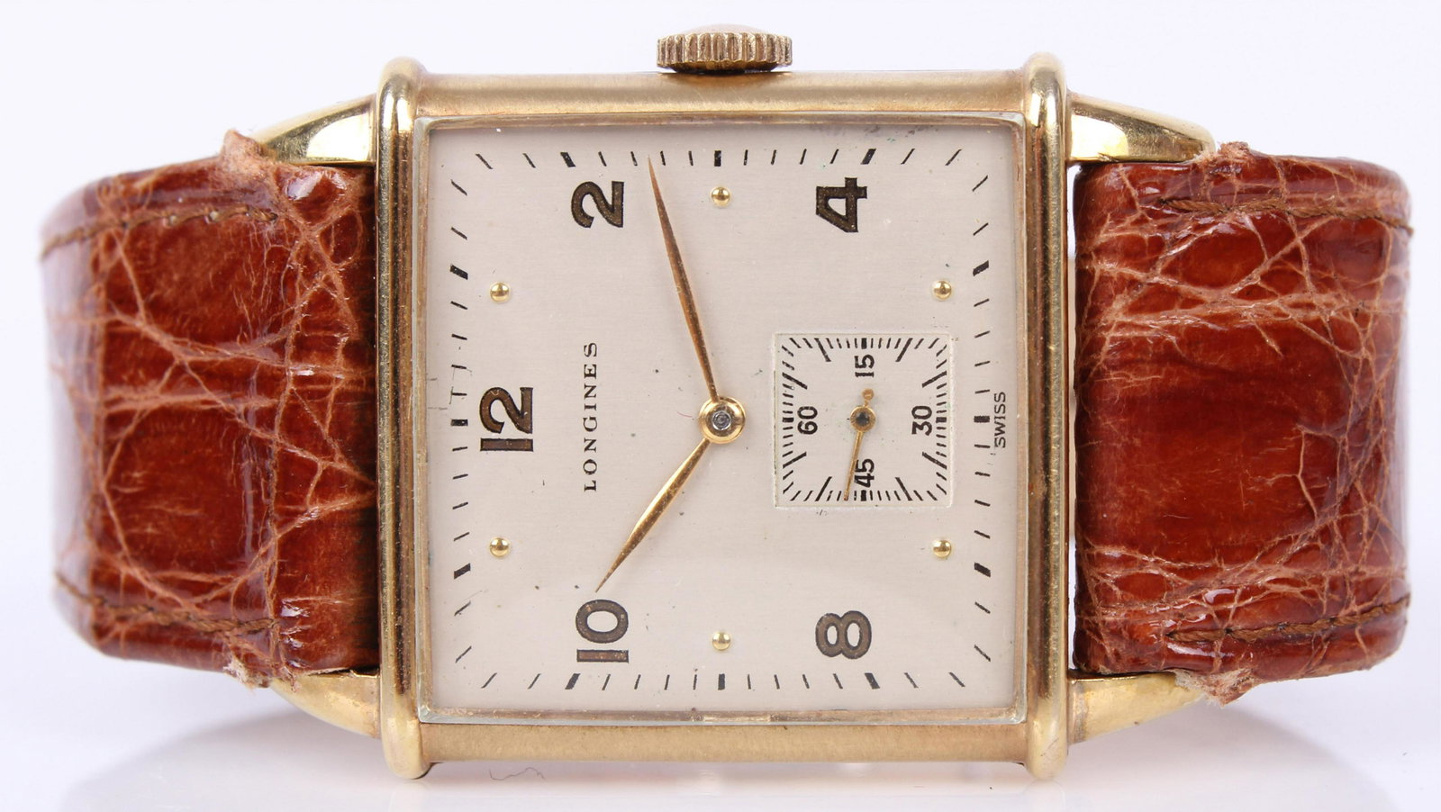 MENS LONGINES 10K YELLOW GOLD FILLED WRIST WATCH: 97185MENS LONGINES 10K YELLOW GOLD FILLED WRIST WATCH Longines men's square case 10k yellow gold filled wristwatch. Wadsworth case, 7026609 serial 8LN movement. Brown leather Bradford band. Weight: 24