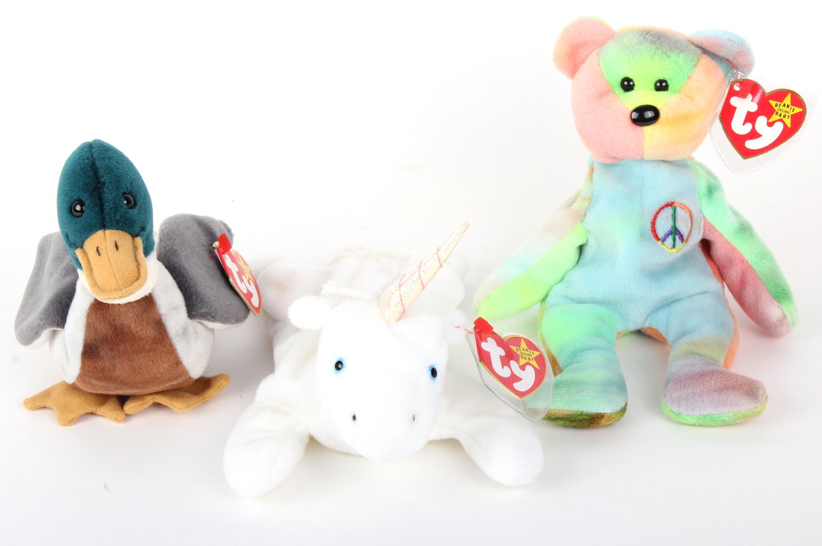 BEANIE BABIES JAKE, MYSTIC, & PEACE BEAR: 97282BEANIE BABIES JAKE, MYSTIC, & PEACE BEAR Jake the Mallard (1998), Mystic the Unicorn with coarse mane (1994), and Peace Bear style 4053 (1997). These 3 Beanie Babies repeatedly show up on top ten