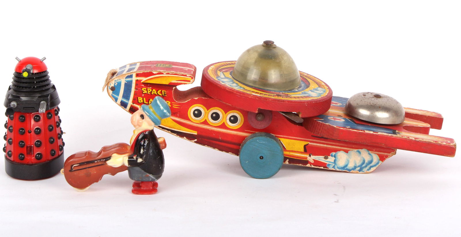 VINTAGE TOYS - SPACE BLAZER, JIMINY CRICKET, ETC.: 97305VINTAGE TOYS - SPACE BLAZER, JIMINY CRICKET, ETC. Vintage toys to include a Fisher Price Space blazer pull toy, a Jiminy Cricket walker toy, and a modern 2010 red Dalek toy from the television se
