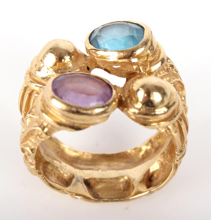 18K YELLOW GOLD PURPLE SPINEL & BLUE SAPPHIRE RING: 18K YELLOW GOLD PURPLE SPINEL & BLUE SAPPHIRE RING 18K yellow gold ring (size 8.5) to include one 5.6mm x 7.7mm oval cut purple spinel gemstone, and one 6.7mm x 8.0mm oval cut pastel blue sapphire gem