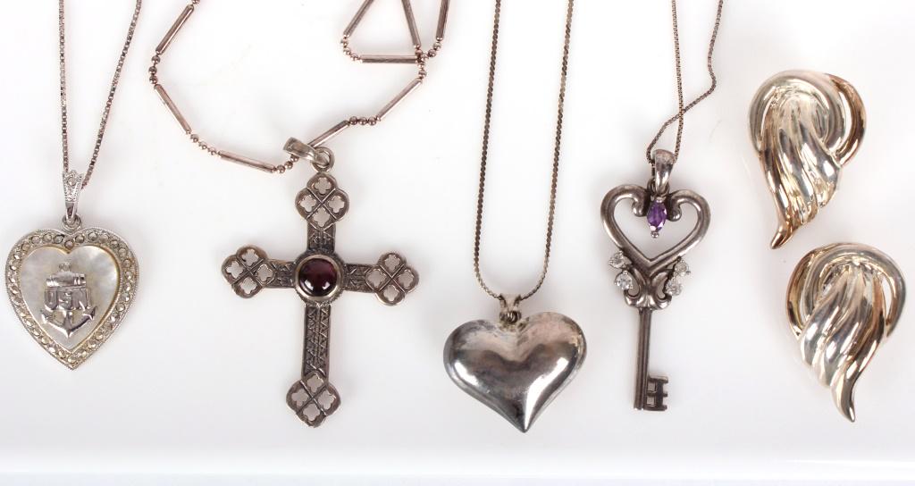 LADIES STERLING SILVER JEWELRY - NECKLACES EARRING: LADIES STERLING SILVER JEWELRY - NECKLACES EARRING To include: two heart pendant necklaces, a cross necklace, a key necklace, and a pair of earrings. All marked sterling. Weight: 34.6 grams Condition: