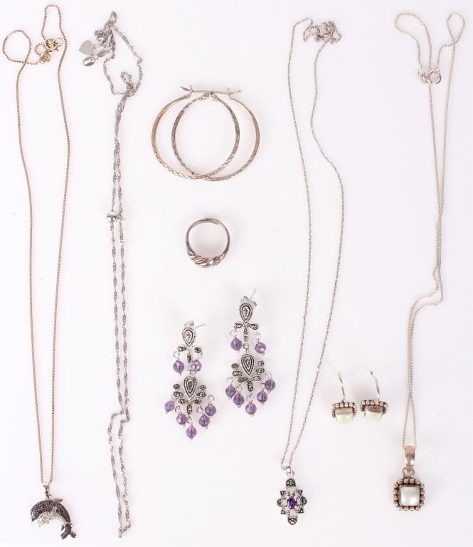 LADIES STERLING SILVER JEWELRY - EARRINGS BRACELET: LADIES STERLING SILVER JEWELRY - EARRINGS BRACELET To include a marcasite earring and necklace set, a mother of pearl earring and necklace set, a dolphin necklace, a pair of hoop earrings, a ring, and