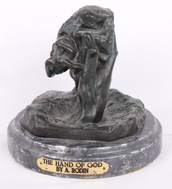 THE HAND OF GOD BY AUGUSTE RODIN BRONZE REPLICA: THE HAND OF GOD BY AUGUSTE RODIN BRONZE REPLICA Bronze replica of the sculpture "The Hand of God" by Auguste Rodin with a marble base. Small metal nameplate on the base. Size: 7.75 X 8.25" Condition:
