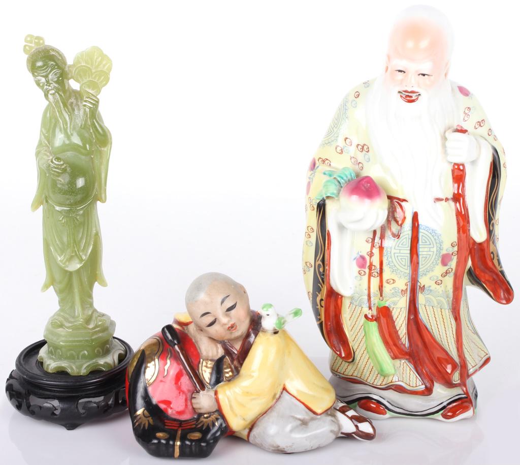 ASIAN PORCELAIN & SOAPSTONE FIGURINES - LOT OF 3: ASIAN PORCELAIN & SOAPSTONE FIGURINES - LOT OF 3 Asian porcelain and soapstone figurines to include one Asian porcelain figure holding a peach and staff, one Asian porcelain figurine playing an instru