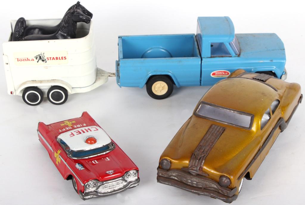 VINTAGE TOY HAJI FRICTION CAR & TONKA TRUCK - (3): VINTAGE TOY HAJI FRICTION CAR & TONKA TRUCK - (3) Set of vintage toy cars to include one red Haji tin friction Fire Chief car, one blue Tonka pickup truck with a Tonka Stables trailer pulling two toy 