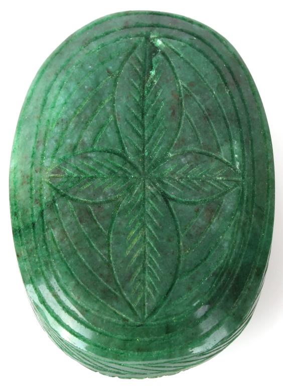 ZAMBIAN HAND CARVED OVAL EMERALD 673 CT LEAVES: ZAMBIAN HAND CARVED OVAL EMERALD 673 CT LEAVES Zambian hand carved emerald mineral specimen with leaf design on the front and back. Oval shaped. Weight: 134.6 Grams Condition: Very fine