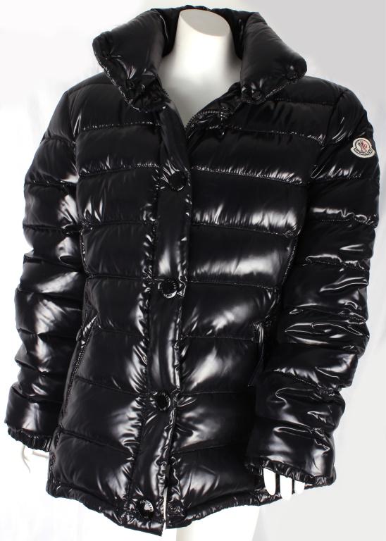 MONCLER LADIES DOWN COAT SIZE 4 W/ ORIGINAL BOOK: MONCLER LADIES DOWN COAT SIZE 4 W/ ORIGINAL BOOK Moncler Ladies black down coat, size 4, with original booklet. Has comic panel sewn into the inside of the left side. Has distinctive Moncler zippers o