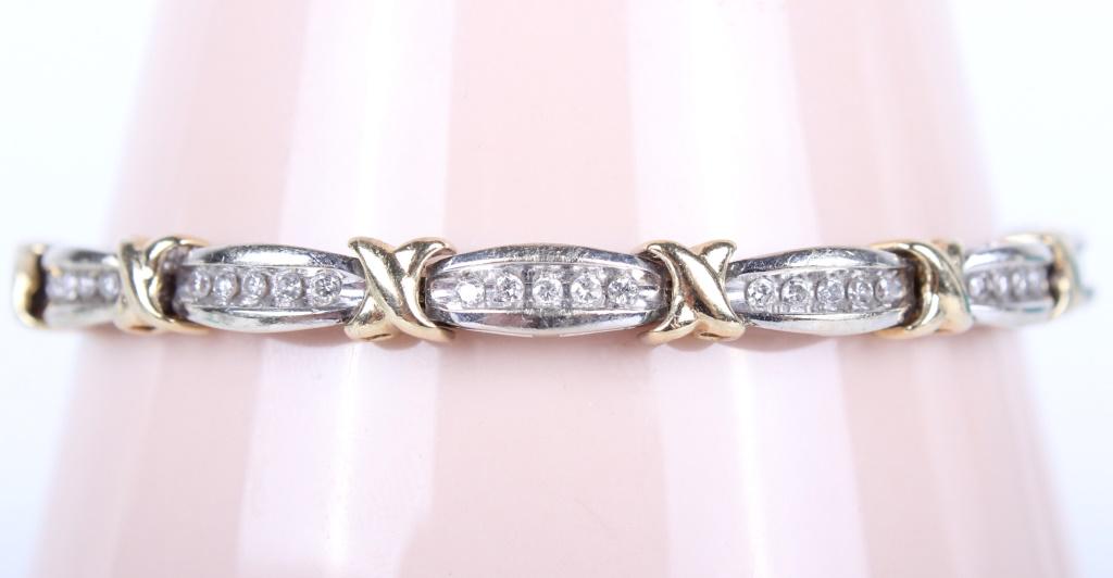 LADIES 10K YELLOW & WHITE GOLD DIAMOND BRACELET: 10007LADIES 10K YELLOW & WHITE GOLD DIAMOND BRACELET Ladies 10K two tone X link bracelet with 65 round white diamonds. Weight: 11.6 grams Size: 7.25"We Can Ship This Item