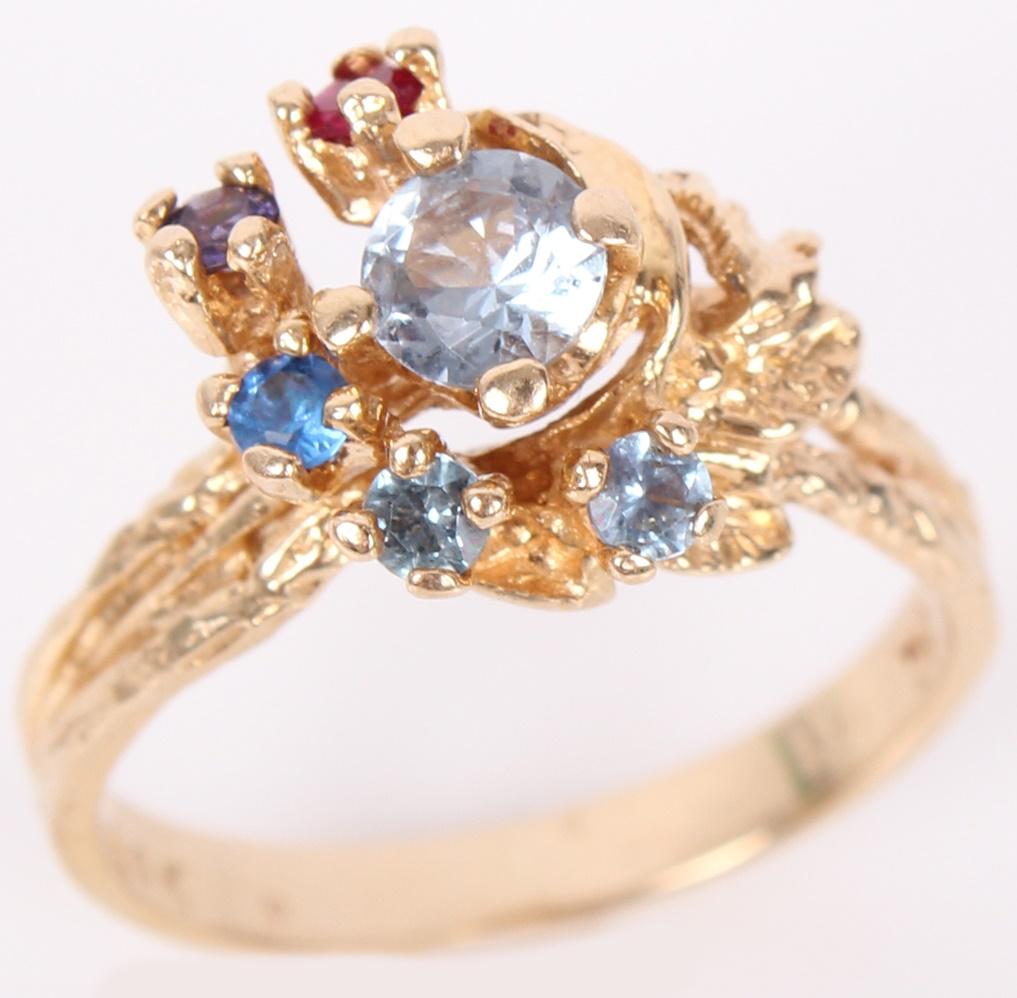 14K YELLOW GOLD LADIES MULTI-COLORED TOPAZ RING: 1002714K YELLOW GOLD LADIES MULTI-COLORED TOPAZ RING 14k yellow gold ladies topaz ring with a .50ct blue topaz gemstone surrounded by .04ct topaz gemstones in various colors. Tested. Weight: 4.8 Grams