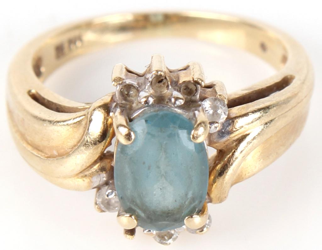 10K YELLOW GOLD DIAMOND TOPAZ LADIES RING: 1041010K YELLOW GOLD DIAMOND TOPAZ LADIES RING10 karat yellow gold diamond topaz ladies ring. Ring features 4 approximately .01 carat diamonds around the center stone and a large blue topaz in the mid