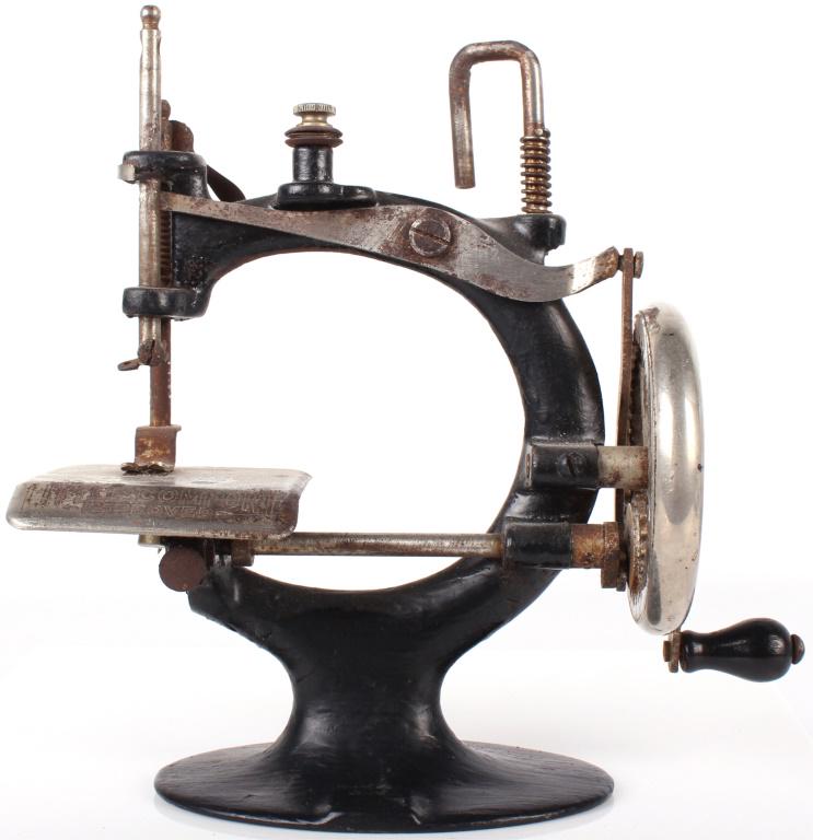 VINTAGE LITTLE COMFORT HAND SEWING MACHINE: 10693VINTAGE LITTLE COMFORT HAND SEWING MACHINEVintage little comfort hand sewing machine. This is the improved model of the little comfort sewing machine. Operated by hand crank on side.