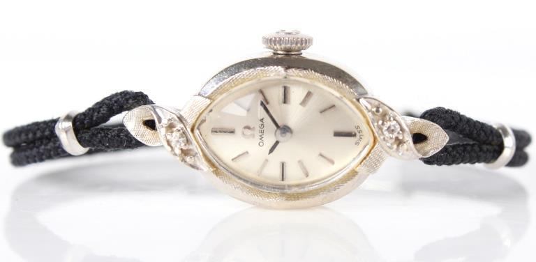 LADIES OMEGA 14K WHITE GOLD DIAMOND WRISTWATCH: 10338LADIES OMEGA 14K WHITE GOLD DIAMOND WRISTWATCH Ladies 14k white gold cased antique wrist watch on braided cord bracelet, Calibre 485 movement. Wristwatch Omega Ladies Weight: 9.5 grams 9.5 grams 