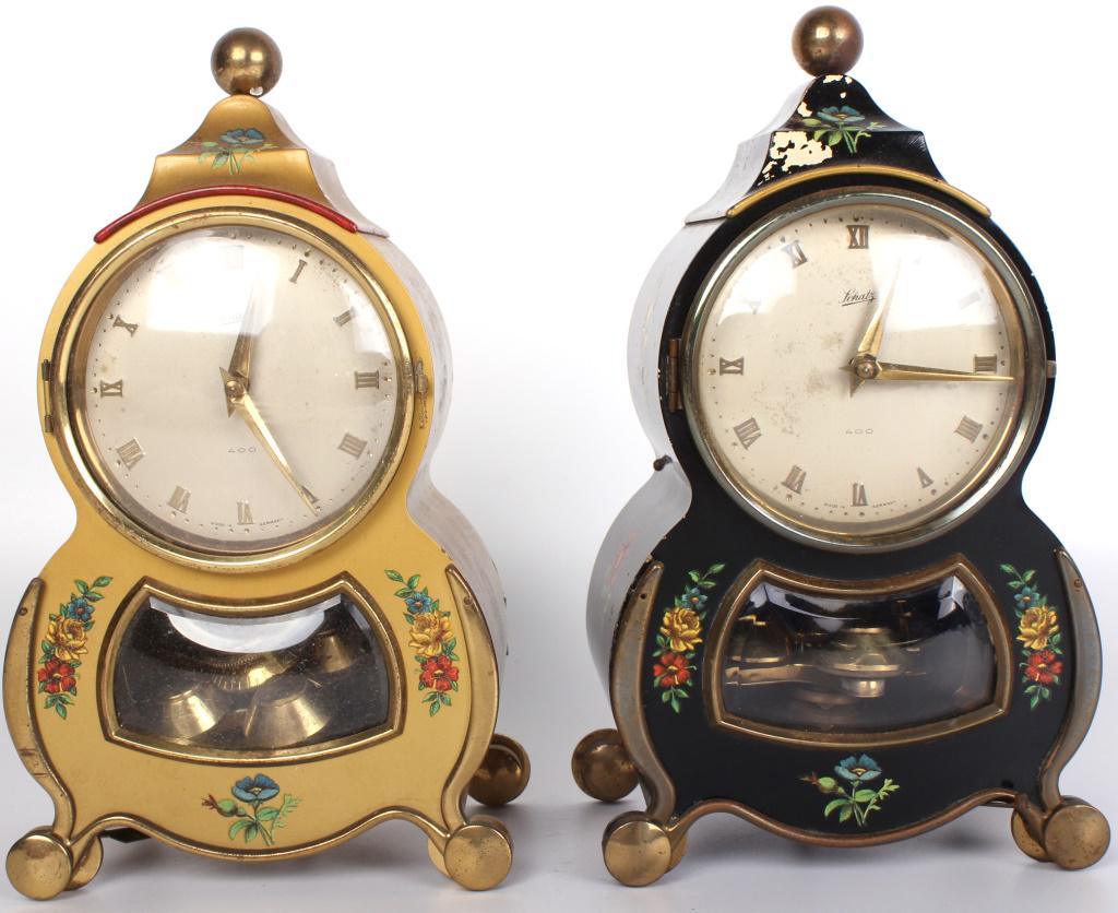 SCHATZ HAND PAINTED WOOD #53 MANTEL CLOCKS (2): 10439SCHATZ HAND PAINTED WOOD #53 MANTEL CLOCKS (2) Schatz undulating shape hand painted wood model #53 mantel clocks to include one with gold lacquer base paint and one with black lacquer base paint.