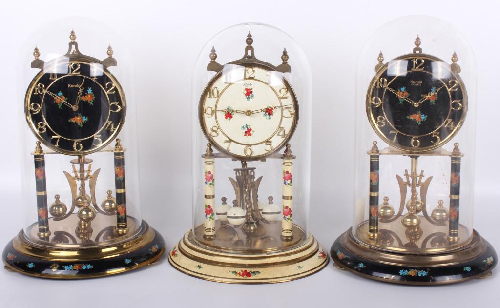 KUNDO GERMAN BLACK MANTEL CLOCKS - LOT OF 3: 10453KUNDO GERMAN BLACK MANTEL CLOCKS - LOT OF 3 Kundo German mantel clocks with black face and brass body. One includes winding key. mantel clock Kundo Size: 12" 12"