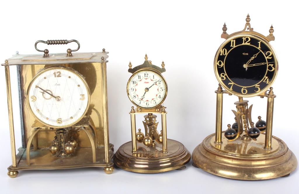 KUNDO GERMAN MANTEL CLOCKS / PARTS - LOT OF 3: 10454KUNDO GERMAN MANTEL CLOCKS / PARTS - LOT OF 3 Kundo German mantel clocks for parts - lot of 3. mantel clock Kundo Size: 12" Condition: Untested. Sold As-Is w/ pieces 12"
