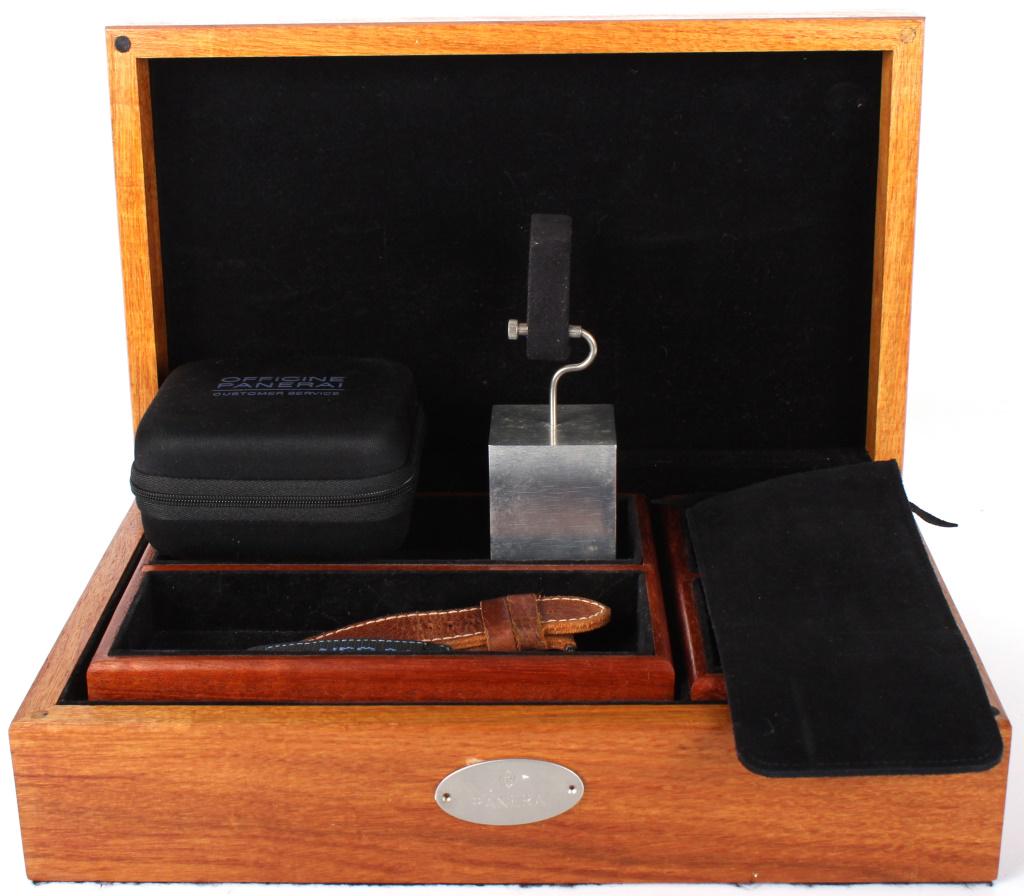 PANERAI WATCH ACCESSORIES BANDS, CASES, & DISPLAY: 10473bPANERAI WATCH ACCESSORIES BANDS, CASES, & DISPLAY Panerai Watch accessories to include one velcro band, one fine leather band, one Panerai watch display stand, one soft case, one oak wood Panera
