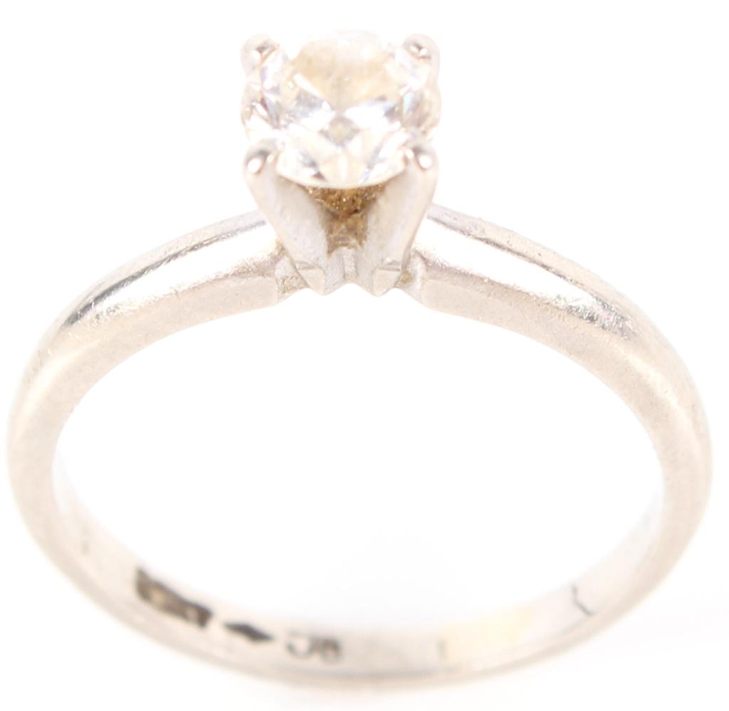 10K WHITE GOLD .33CT DIAMOND LADIES RING: 1060710K WHITE GOLD .33CT DIAMOND LADIES RING 10K white gold .33CT diamond ladies ring. Diamond is J in color and SI1 in clarity. Diamond Weight: 2.1 gramsSize: 5 Condition: Very fine. 2.1 grams 5