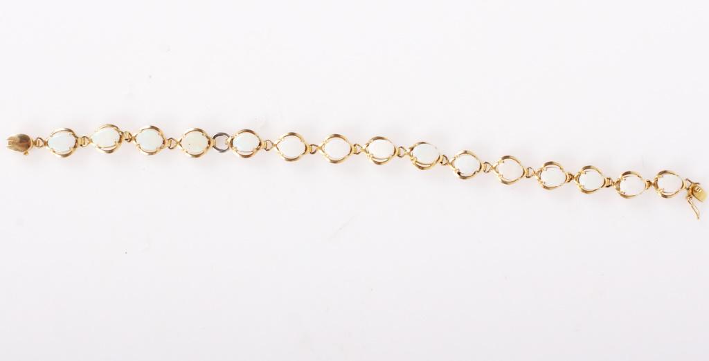14K YELLOW GOLD WHITE OPAL LADIES BRACELET: 1067414K YELLOW GOLD WHITE OPAL LADIES BRACELET 14 karat yellow gold white opal ladies bracelet. Bracelet has 15 approximately 0.3 carat stones for a total of 4.5 ctw. Clasp is marked "14k".Weight: 6.