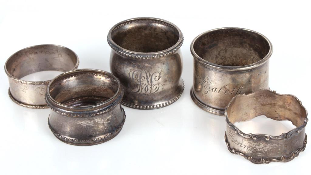 STERLING SILVER NAPKIN RINGS- LOT OF 5: 10958STERLING SILVER NAPKIN RINGS- LOT OF 5 Sterling silver napkin rings, assorted sizes- lot of five. Weight: 84.3 Grams Size: 1.5"Condition: Fine- Tarnished 1.5"