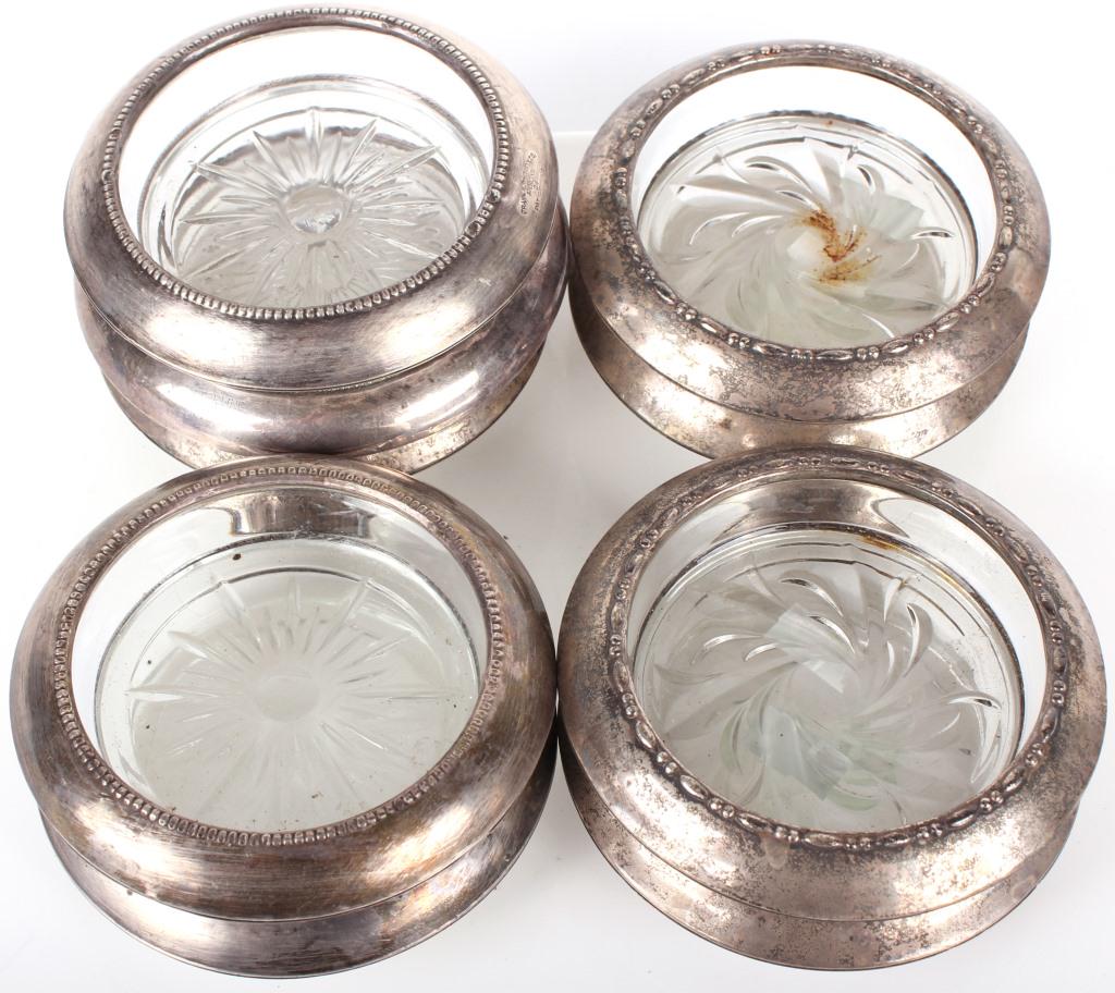 FRANK M WHITING STERLING SILVER GLASS COASTERS - 9: 10962FRANK M WHITING STERLING SILVER GLASS COASTERS - 9 Frank M Whiting sterling silver and glass coasters. Each coaster has a glass base with sterling silver covering the top. Weight: 1464.1 GramsSiz