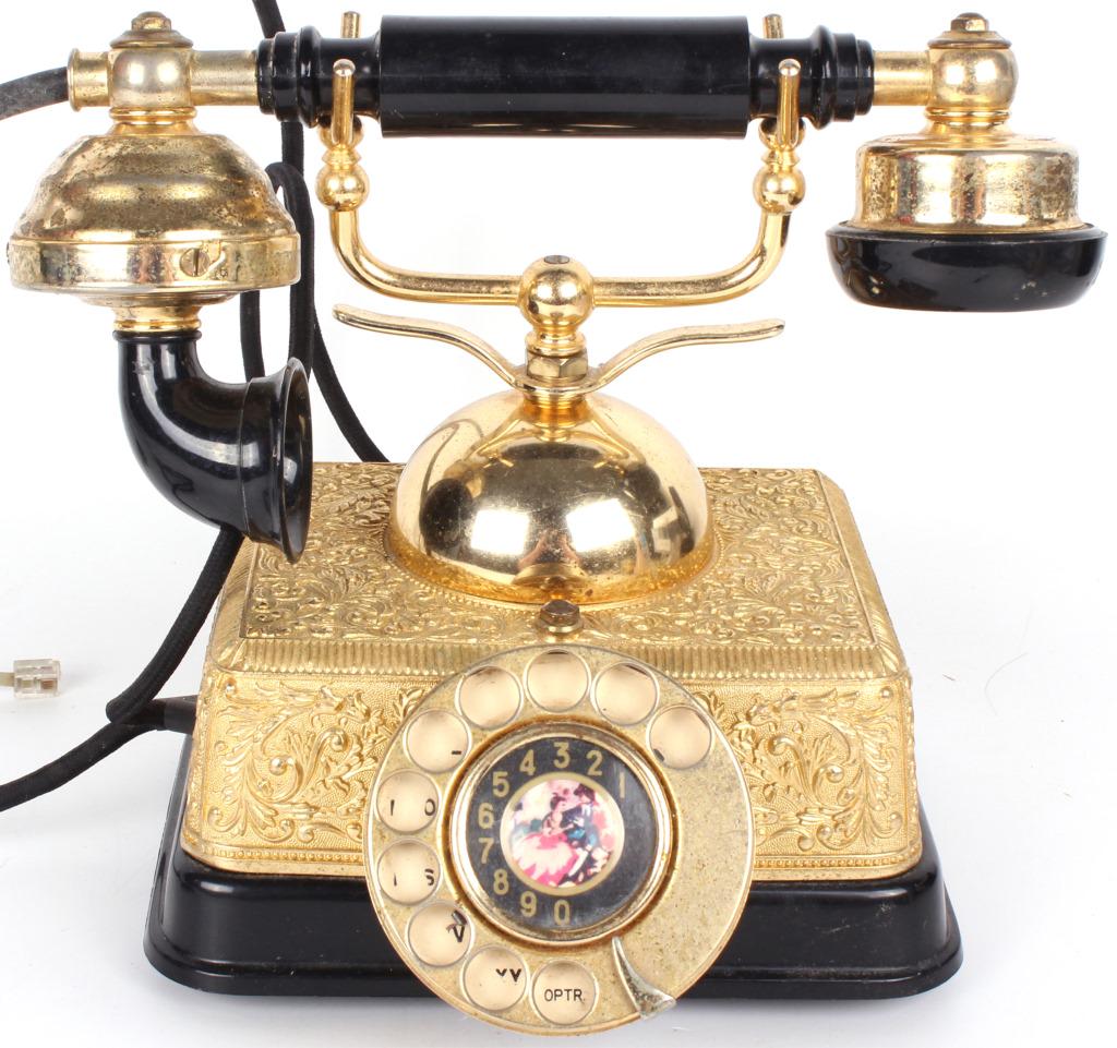 GOLDEN VINTAGE VICTORIAN STYLE ROTARY TELEPHONE: 11164GOLDEN VINTAGE VICTORIAN STYLE ROTARY TELEPHONE Vintage golden Victorian style rotary phone and all cords, engraved with floral embroidery. Contains an image of a cartoon couple dancing in dial.S