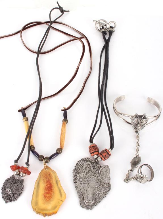 WOLF THEMED NATIVE AMERICAN STERLINGSILVER JEWELRY: 11285WOLF THEMED NATIVE AMERICAN STERLINGSILVER JEWELRY Collection of 4 wolf themed vintage Native American sterling silver jewelry pieces. Lot includes 2 rope necklaces with red beads and a silver pe