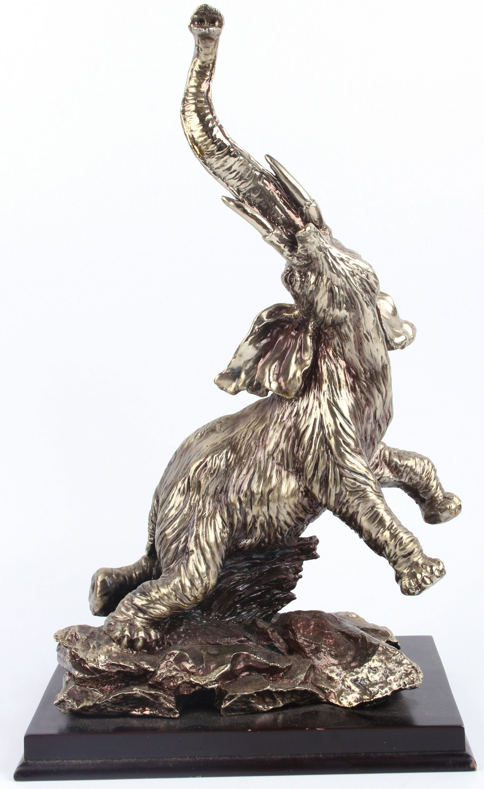 SILVER ROARING ELEPHANT STATUE: 118232 SILVER ROARING ELEPHANT STATUE Beautiful intricate silver statue of a large elephant with standing on its hind legs and roaring with its trunk in the air. Statue has a very nice wooden baseSize