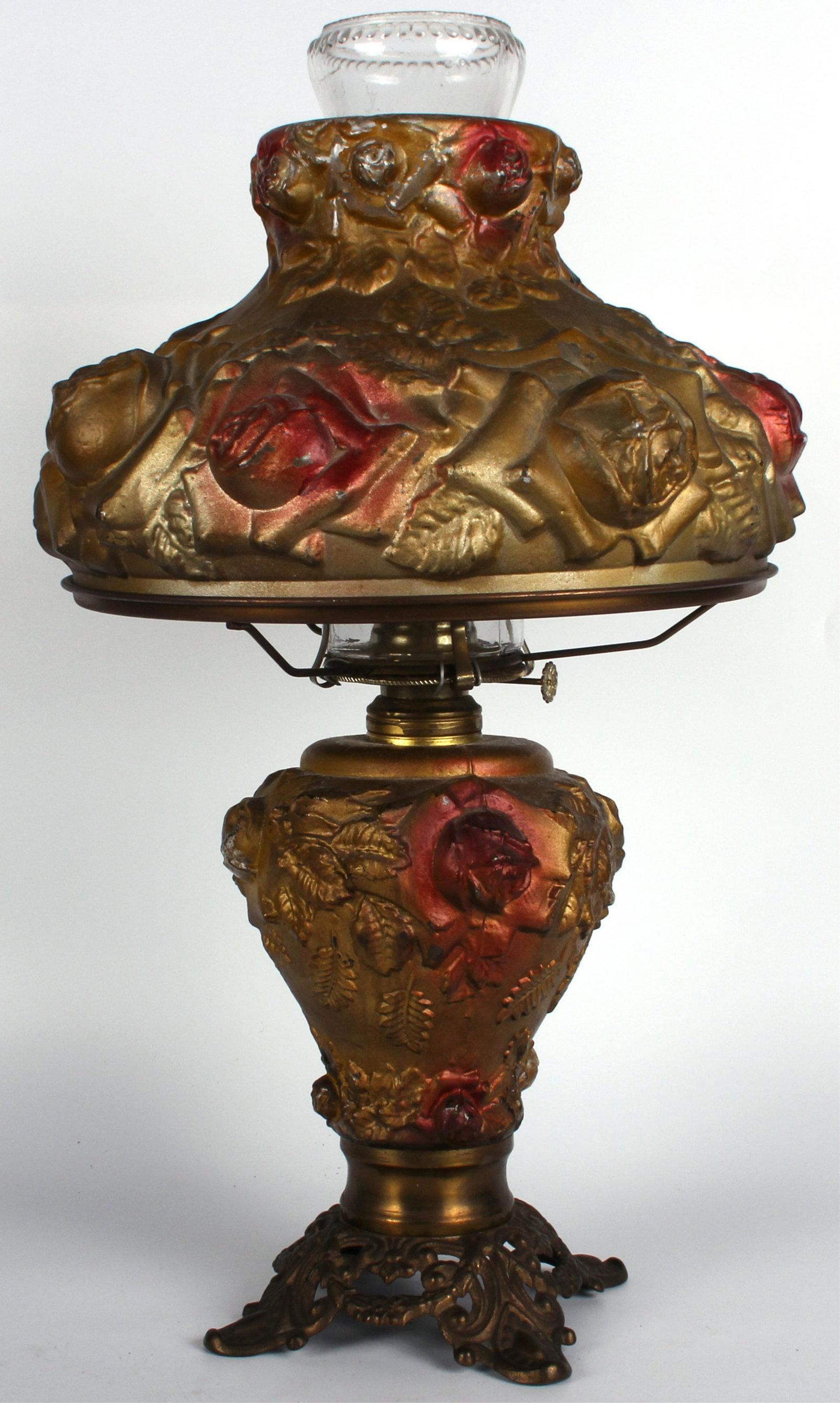 ANTIQUE VICTORIAN GOOFUS GLASS KEROSENE LAMP: 121343 ANTIQUE VICTORIAN GOOFUS GLASS KEROSENE LAMP Antique victorian Goofus glass kerosene lamp - An antique Goofus glass lamp, with original red and gold paint over depictions of flowers.Size: 20 in