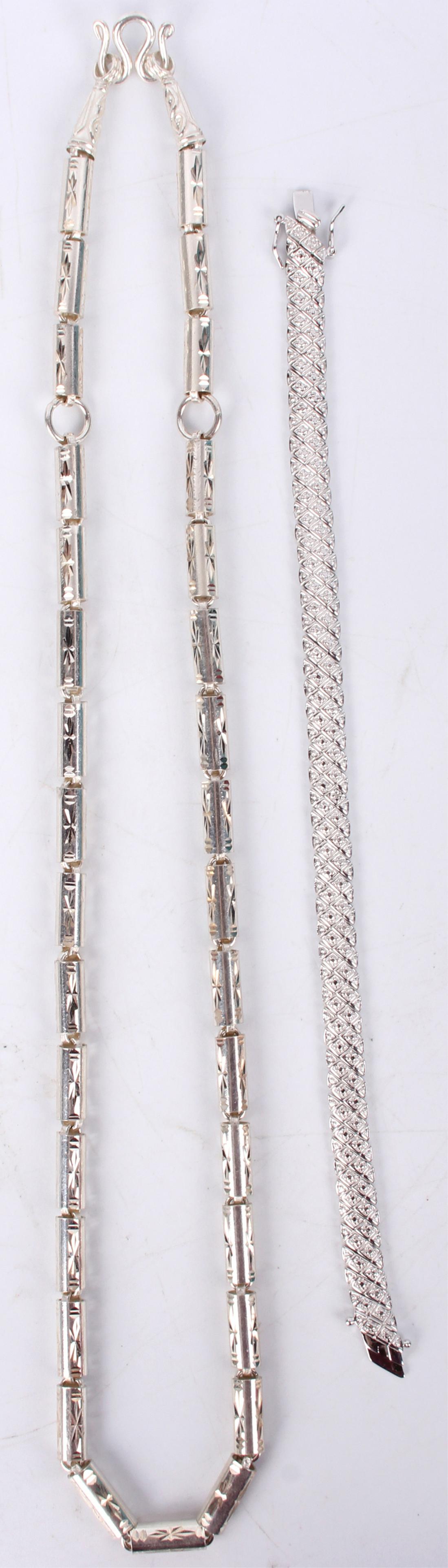 STERLING SILVER BEADED NECLACE & CHAIN BRACELET: 126075 STERLING SILVER BEADED NECLACE & CHAIN BRACELET Sterling silver beaded necklace and chain bracelet. Weight: 64.7 Grams Size: 22" LargestCondition: Very fine.