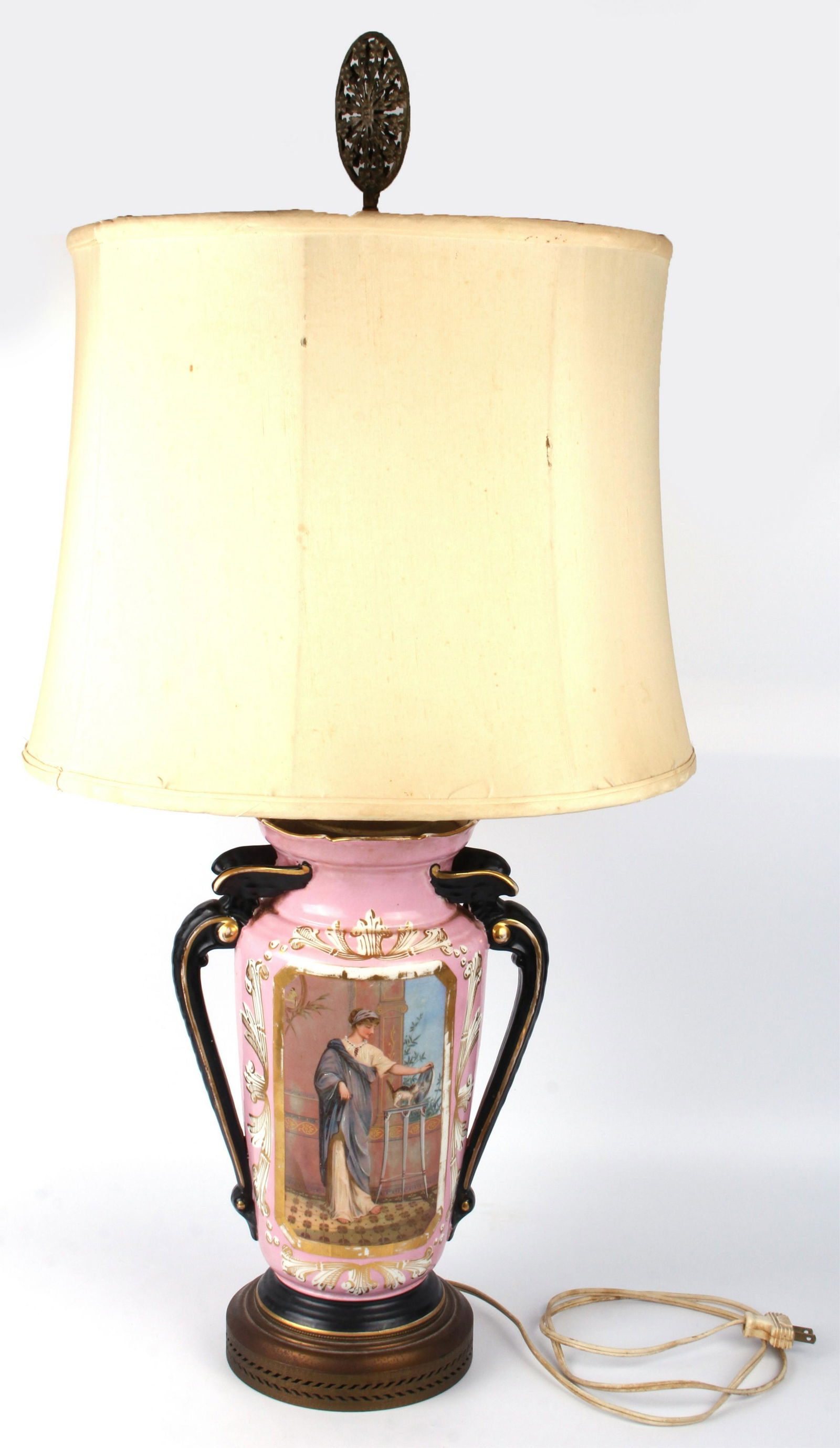 ANTIQUE PORCELAIN HAND-PAINTED PINK TABLE LAMP: 129192 ANTIQUE PORCELAIN HAND-PAINTED PINK TABLE LAMP Antique porcelain hand-painted pink table lamp depicting flowers and an ornate lady playing fondly with her cat. Table lamp comes with a shade, bu