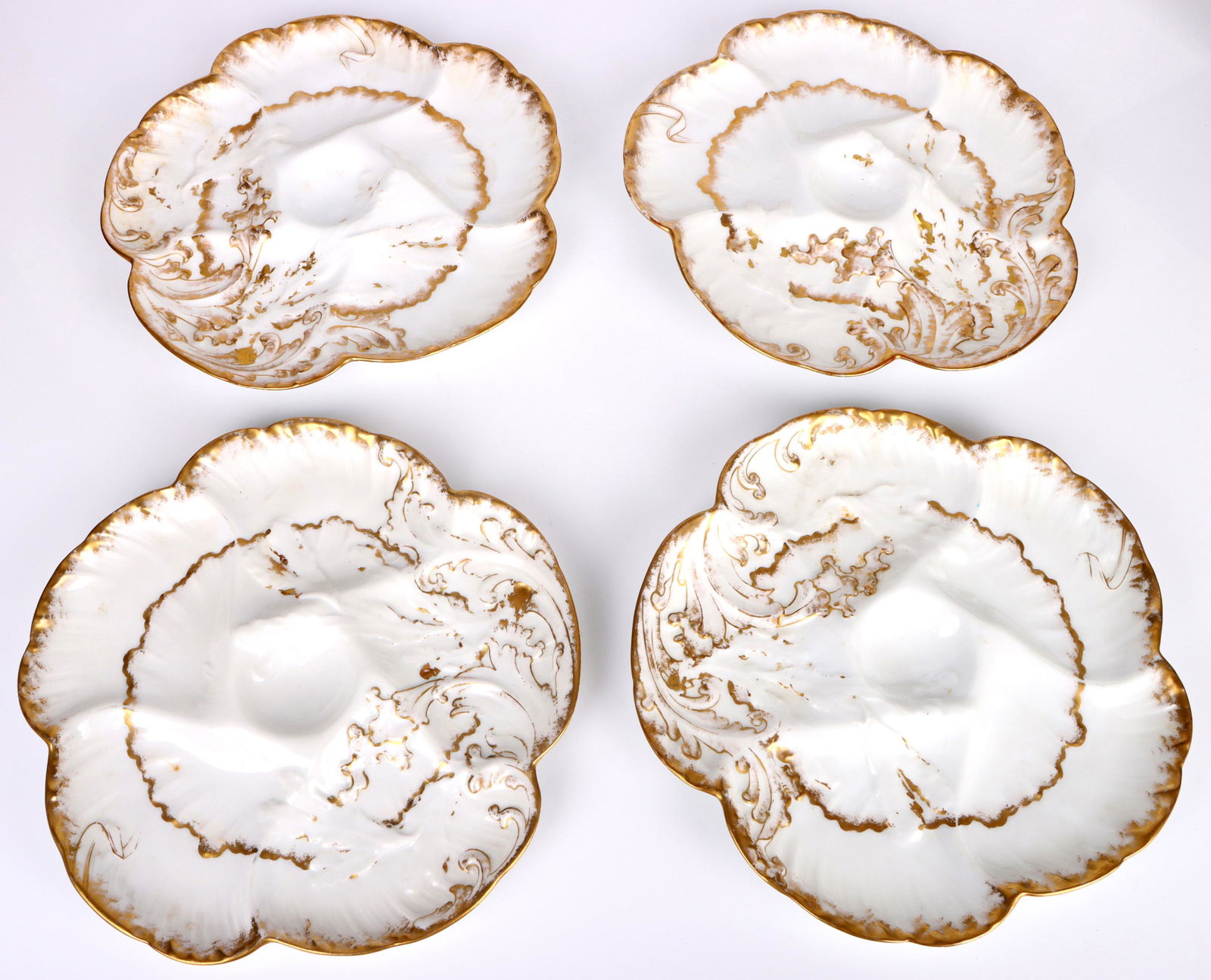 ANTIQUE 1891 LIMOGES OYSTER WHITE & GOLD PLATE SET: 154161 ANTIQUE 1891 LIMOGES OYSTER WHITE & GOLD PLATE SET Antiques 1891 limoges oyster white and gold plates set. Lot of 4. Size: 9" Condition: Wear commensurate with age.