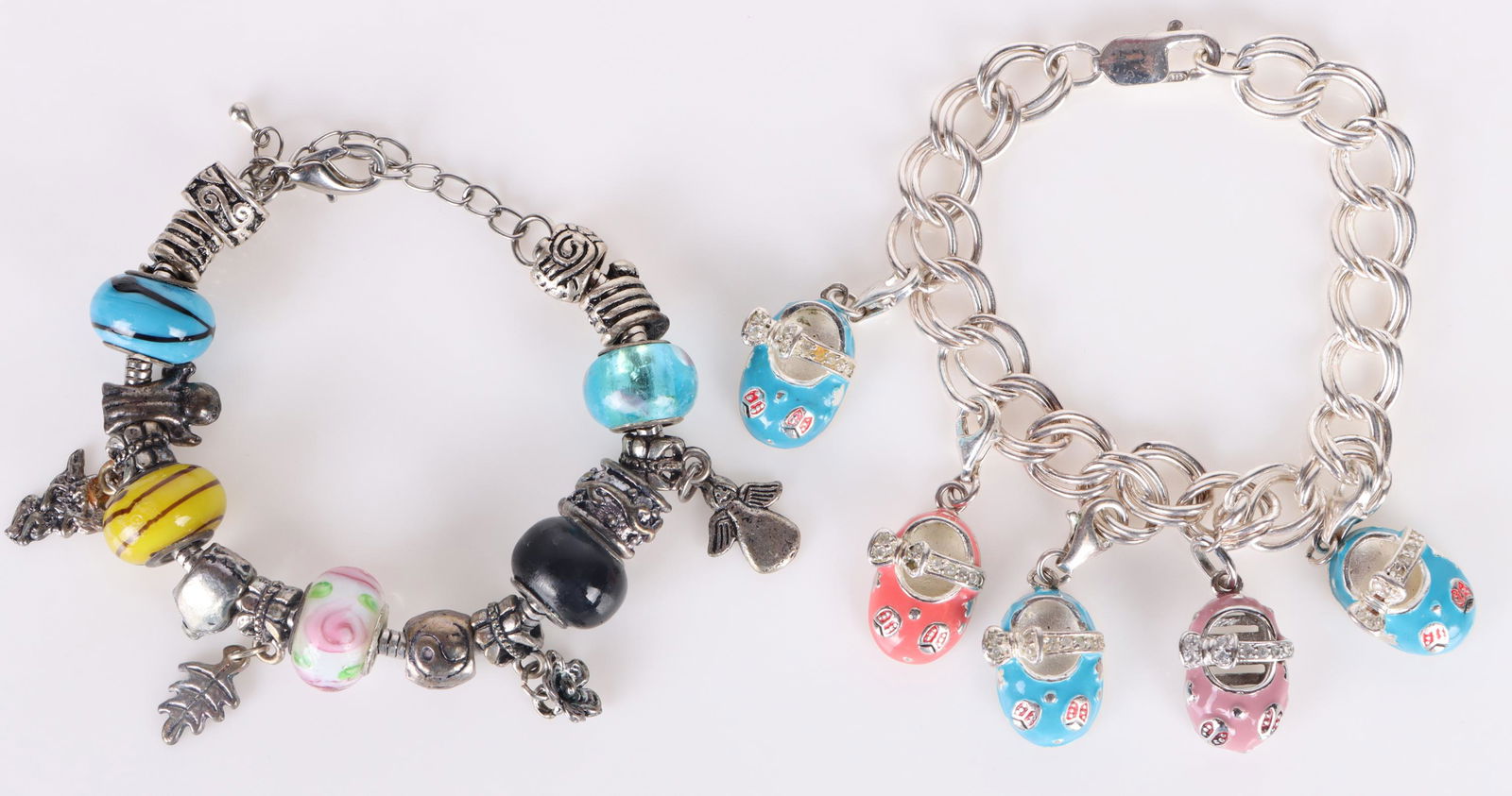 VINTAGE STERLING SILVER DECORATIVE CHARM BRACELETS: 162078 VINTAGE STERLING SILVER DECORATIVE CHARM BRACELETS Vintage sterling silver decorative charm bracelets to include one bracelet with colorful glass beads and silver charms. And one bracelet with