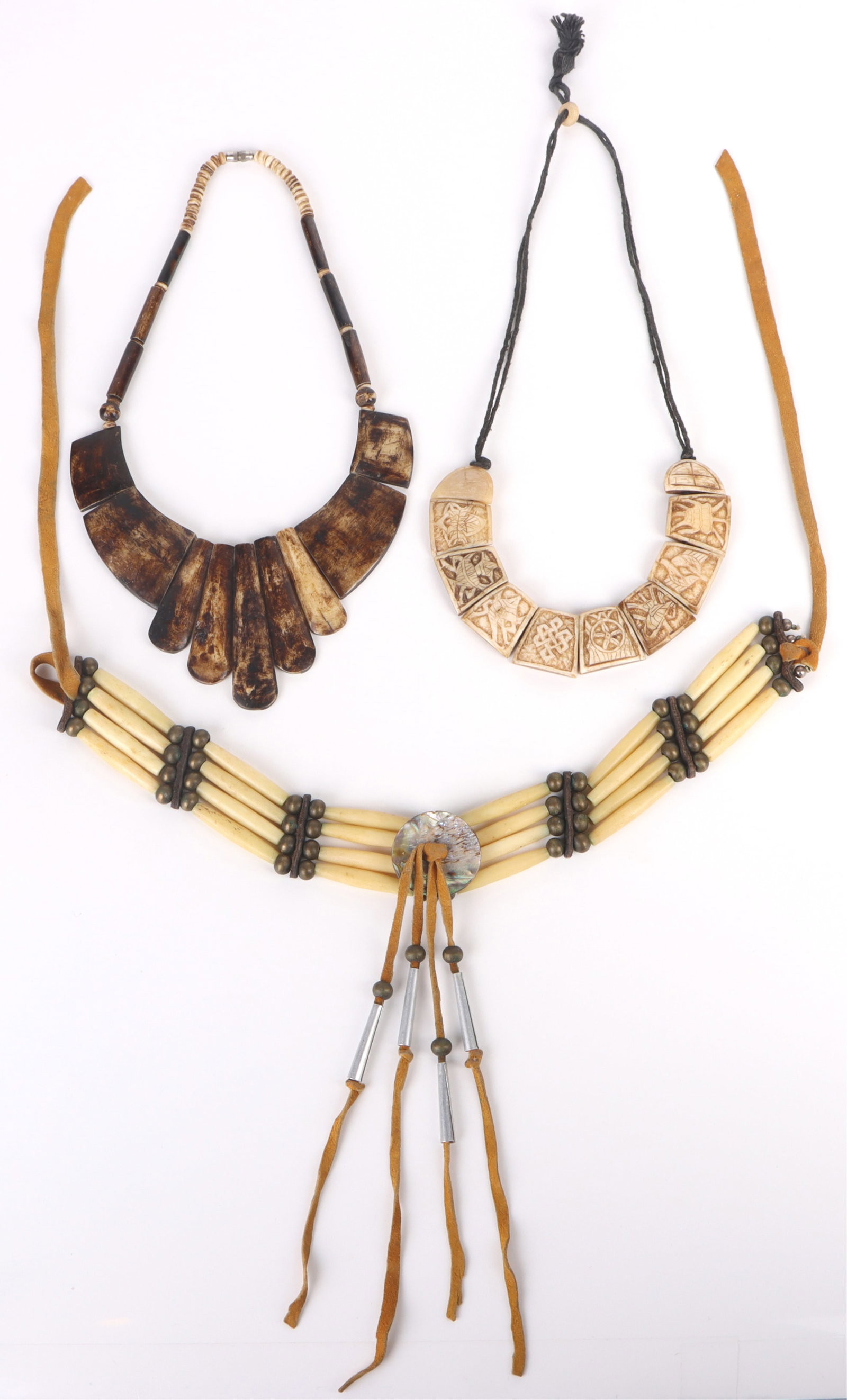 HANDMADE CARVED BONE NECKLACES - LOT OF 3: 163263 HANDMADE CARVED BONE NECKLACES - LOT OF 3 Handmade carved bone necklace to include one intricately carved Nepal necklace, one white bone beaded necklace and one horn carved statement necklace.S