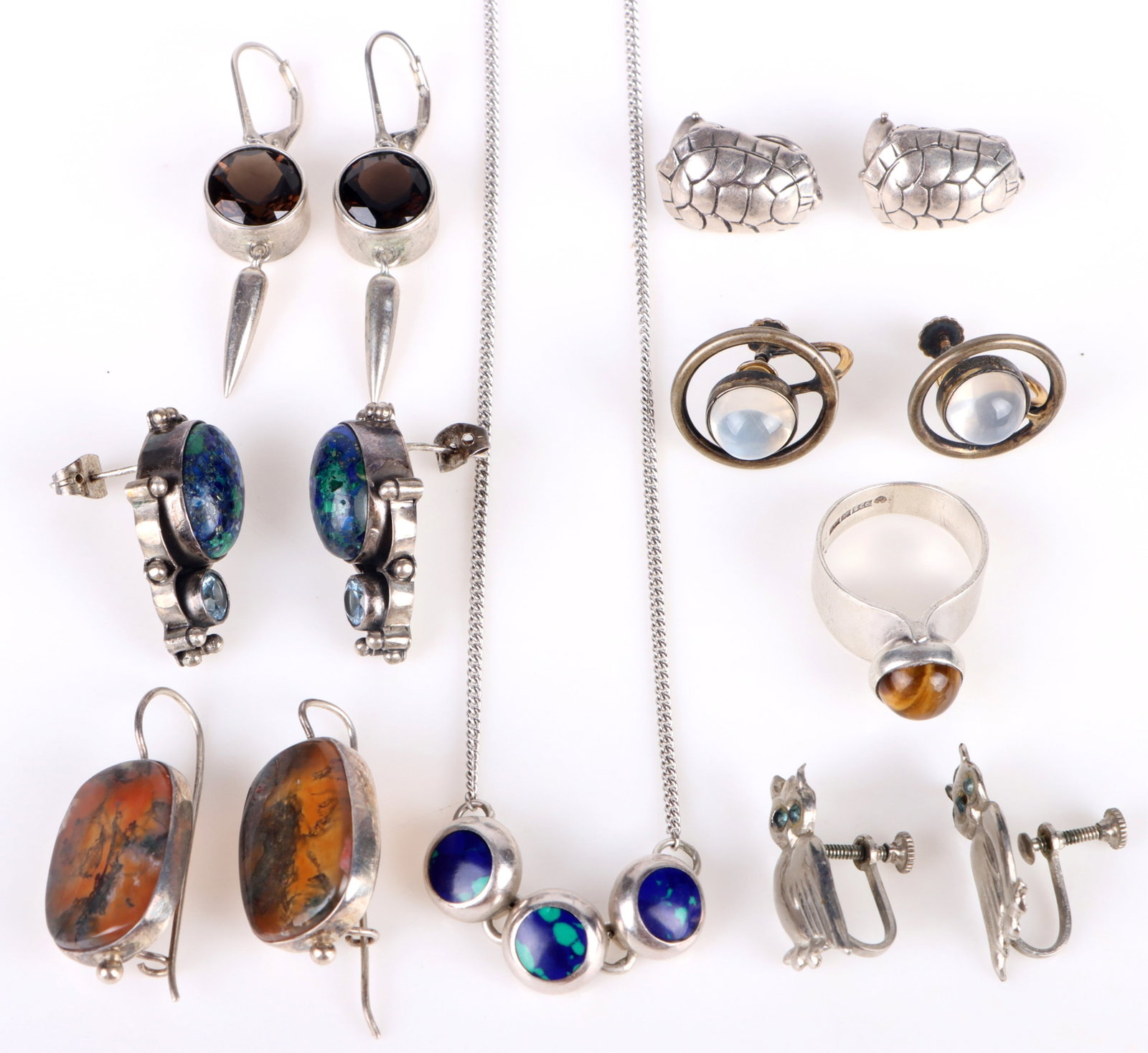 STERLING SILVER GEMSTONE LADIES JEWELRY: 174240 STERLING SILVER GEMSTONE LADIES JEWELRY Sterling silver gemstone ladies jewelry to include jasper, lapis, moonstone, tiger's eye, and topaz. Jewelry includes six pairs of earrings, one ring, an