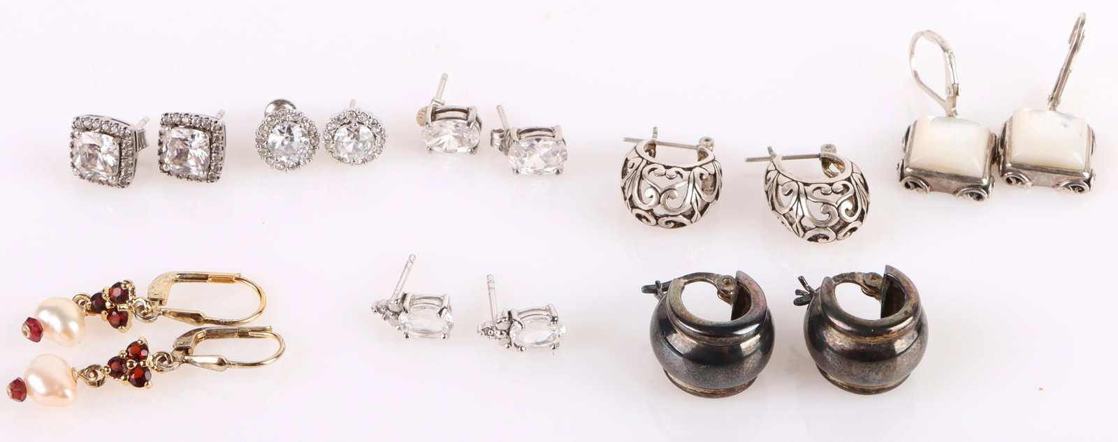 GEMSTONE COLLECTIBLE STERLING SILVER EARRINGS: 177123 GEMSTONE COLLECTIBLE STERLING SILVER EARRINGS Gemstone sterling silver ladies earrings to include one pair of "huggie" earrings, one pair og garnet and pearl earrings, one pair of intricate hoo