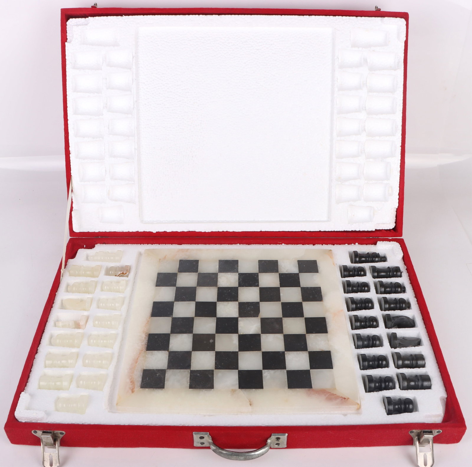VINTAGE HAND CARVED ONYX & STONE CHESS SET: 183371 VINTAGE HAND CARVED ONYX & STONE CHESS SET Vintage Original hand carved Onyx Marble Stone chess board and pieces. Board is 12 X 12". King is 2 1/8" tall. Board and pieces come in box. Size: 14.